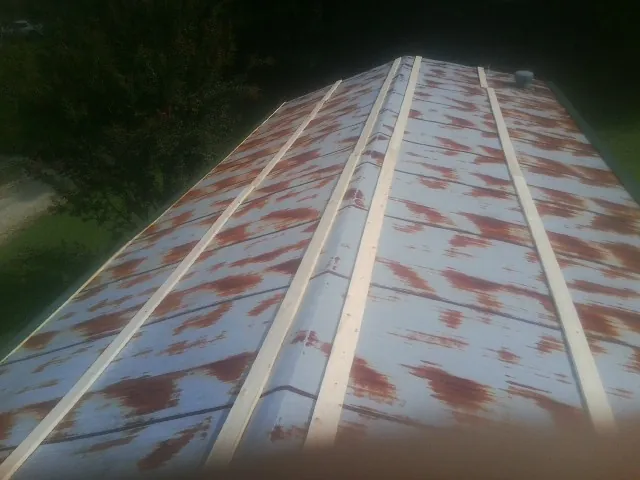 Rusted metal roof panels with new wood purlins before replacement — Storm Damage Roof Repair in Walnut by Roofing Brothers