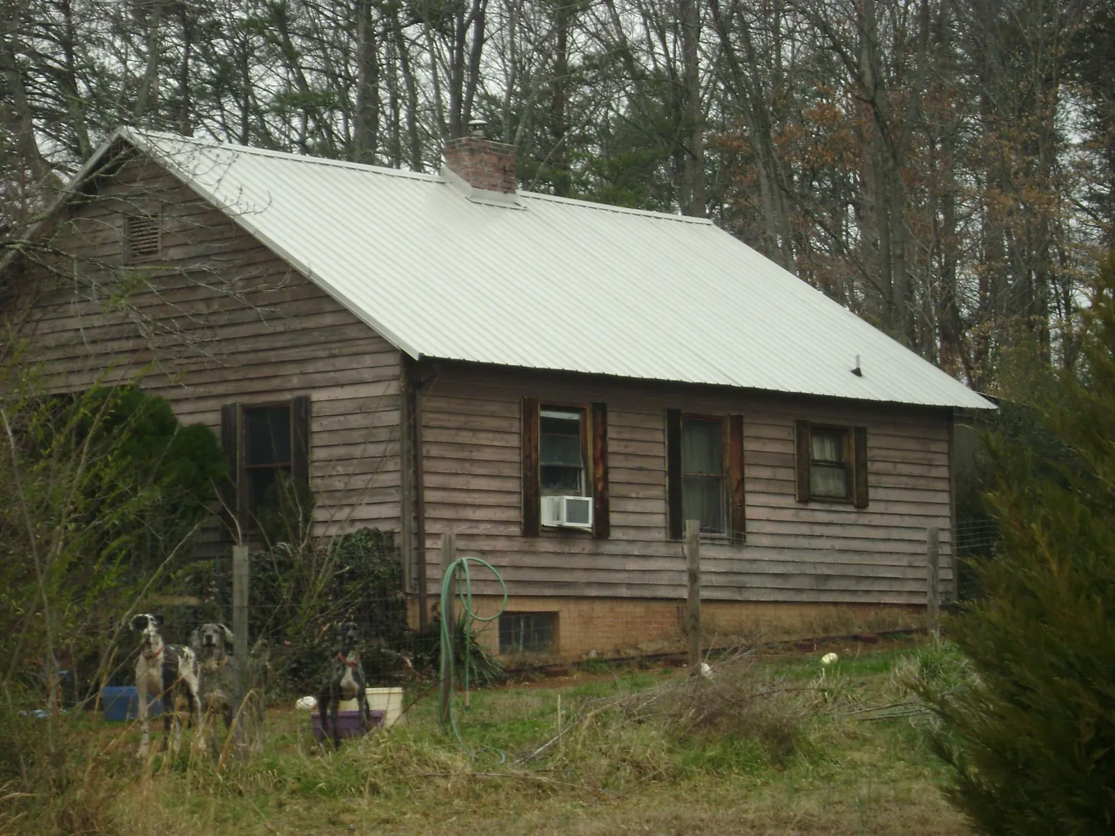 White metal roof on an old wood sided farmhouse, from a Asphalt Shingle Roof Repair job in Walnut
